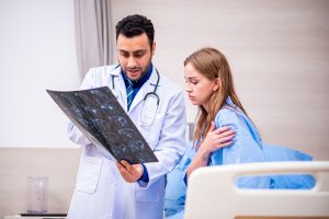 Doctor examining patient in hospital.